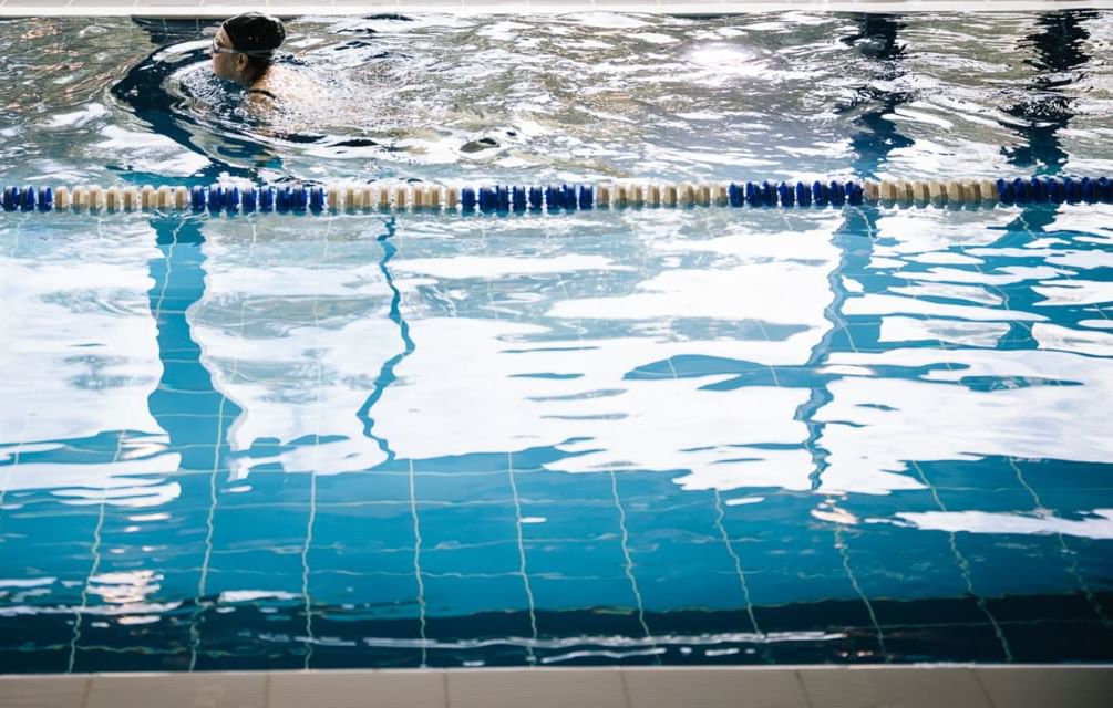 A lady swimming in the indoor pool at Village Hotel Birmingham