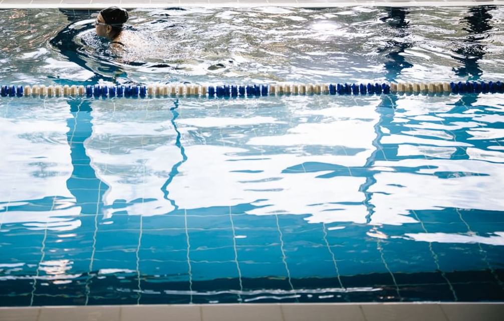 A lady swimming in an indoor pool at Village Hotel Aberdeen