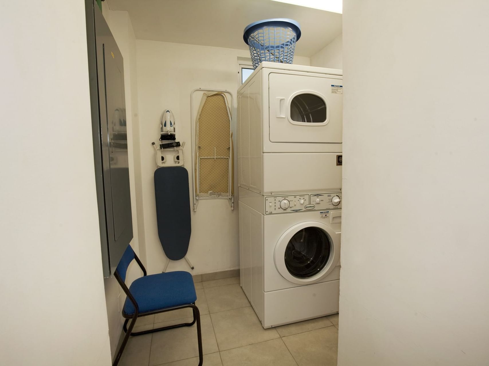 Washing machine, dryer & a chair in Laundry Room at One Hotels
