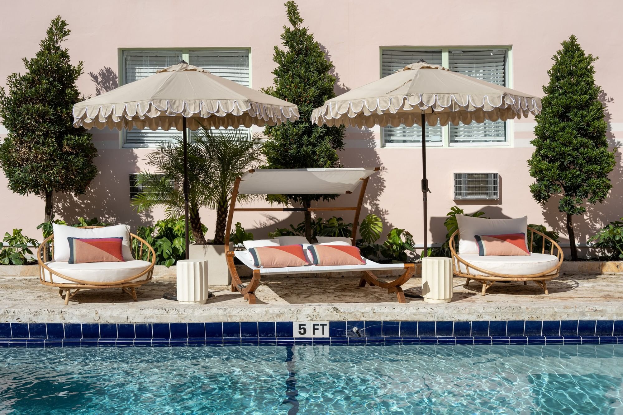 A pool with lounge chairs and umbrellas