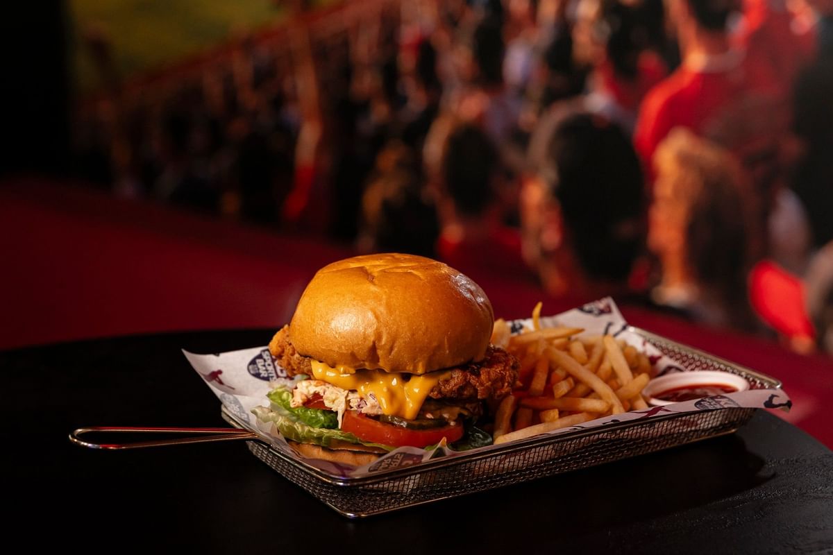 Crispy chicken burger served with fries at KG Sports Bar