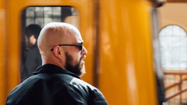 A man with shades looking at something near Hotel Berlin Berlin