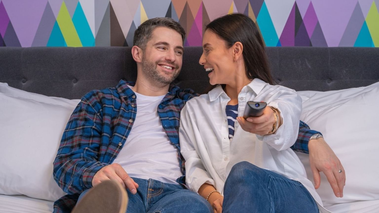 A couple enjoying TV in a bedroom at Hotel Chester St Davids