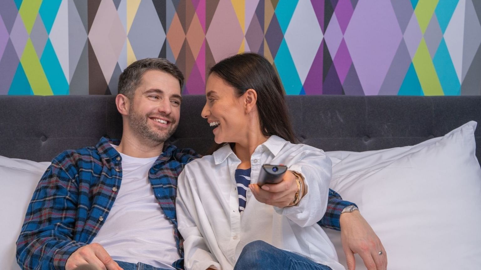 A couple watching tv in a guest room at Village Hotel Aberdeen