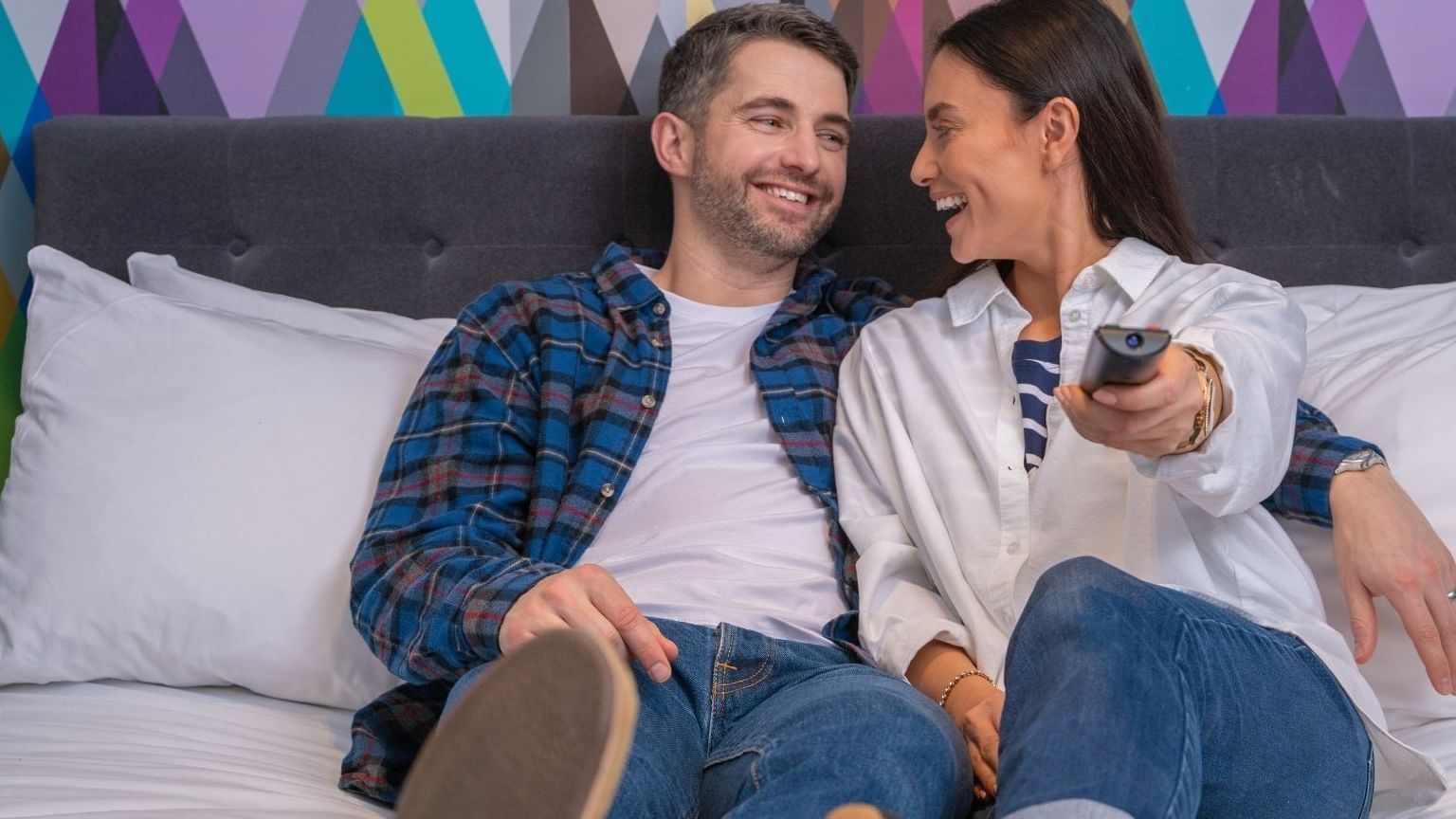 Close up on a couple watching TV in room at Manchester Ashton
