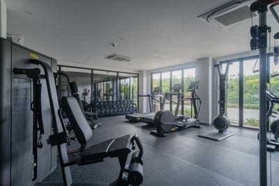 Exercise equipment's with lush greenery view through the large windows in gym at The Hub Acunmeyda