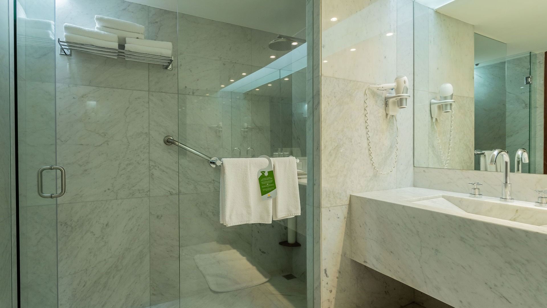 King Viceroys Suite shower featuring marble tile walls and a modern glass-enclosed design at Camino Real Polanco Mexico