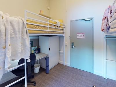 Twin Loft room with two loft bunk beds and desks underneath at UniLodge Herston.