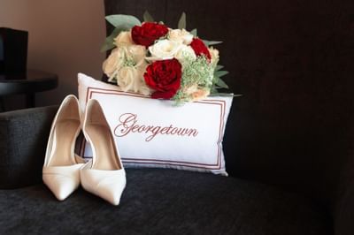 pillow that says georgetown with flowers and heels