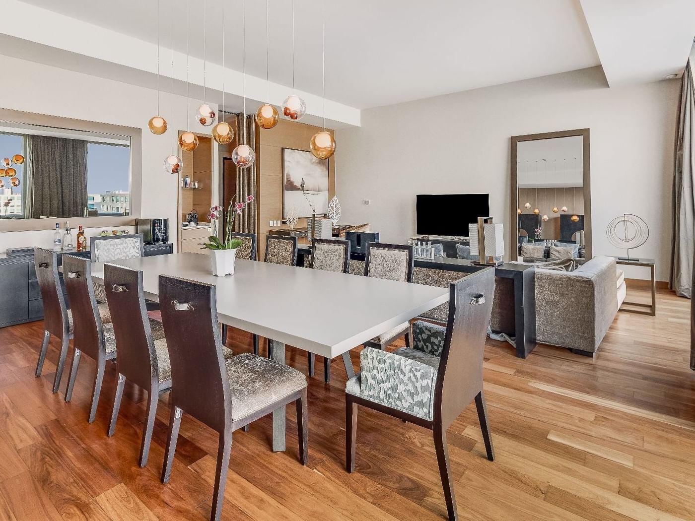 Dining table with living area in Sol Presidential Suite at Fiesta Americana Travelty