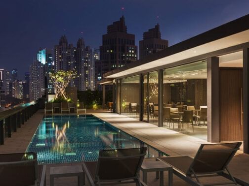 Outdoor rooftop pool with sun loungers at LK Singapore Serviced Apartments