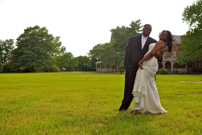 Newlyweds posing in the garden at Kellogg Conference Center