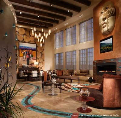 Grand, artfully decorated lobby at Hilton Santa Fe Buffalo Thunder featuring soaring ceilings, cozy seating, and a fire pit