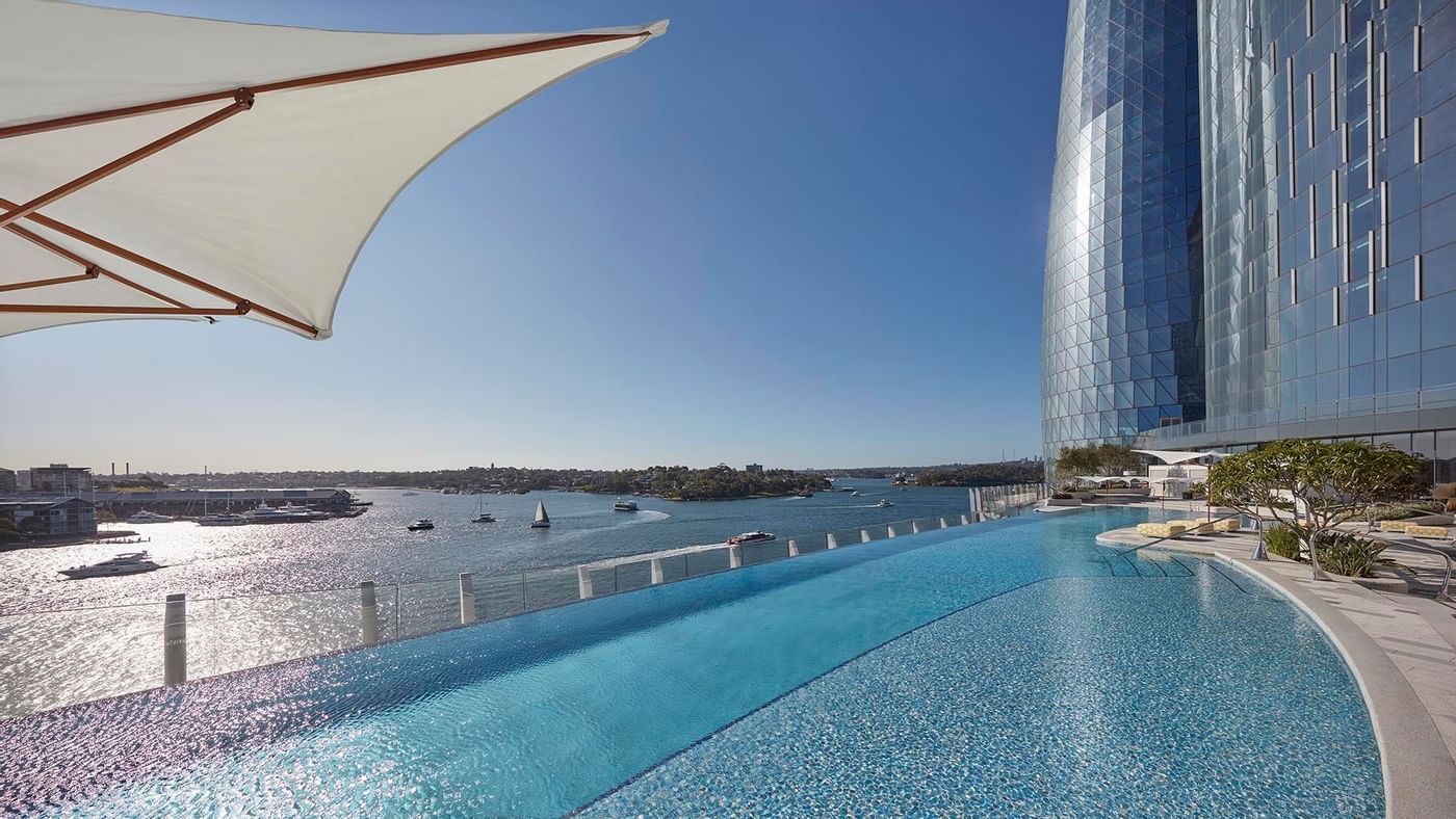 Pool area with sun loungers at Crown Hotels