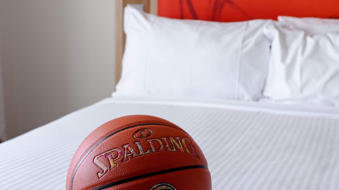 Spalding basketball on the neatly made bed in Superior Spa Suites at Novotel Sydney Olympic Park