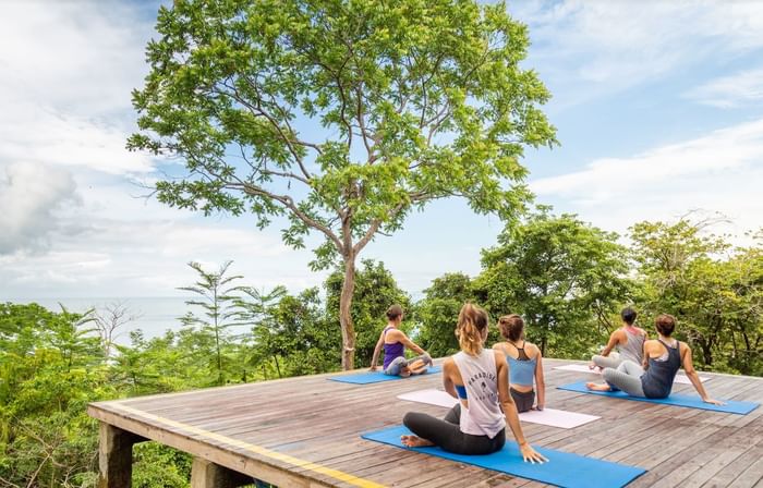 Ladies doing yoga outdoors in the Yoga Deck at Los Altos Resort