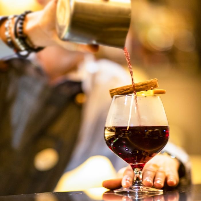 Close up of bartender pouring wine at Novotel Melbourne