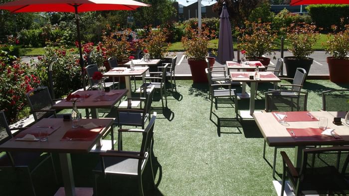 Outdoor dining tables in a restaurant at The Originals Hotels