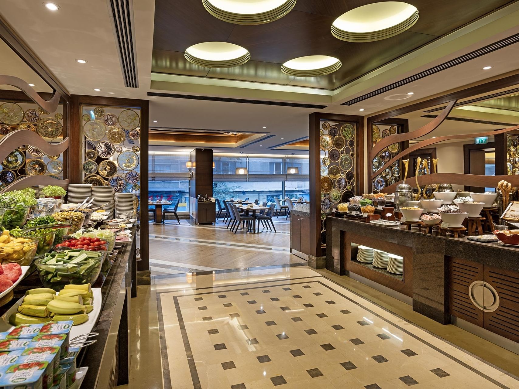 Buffet breakfast at Alesta Restaurant and the dining area with tables and chairs.