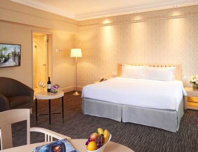 King bed in Deluxe Room with carpeted floors at York Hotel Singapore