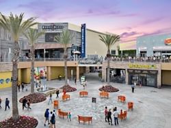People walking around and sitting in the Anaheim Gardenwalk open-air shopping center.