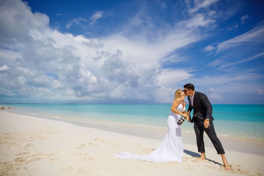 Wedding couple kissing at the beach at Somerset On Grace Bay
