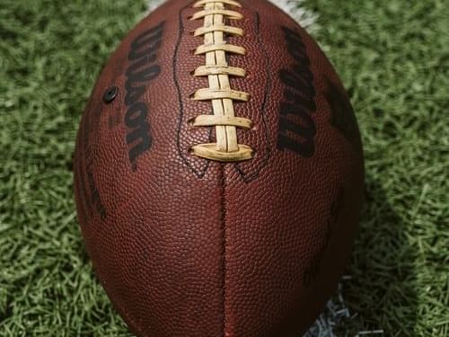 A closeup picture of a football on a field