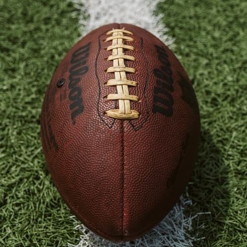 A closeup picture of a football on a field