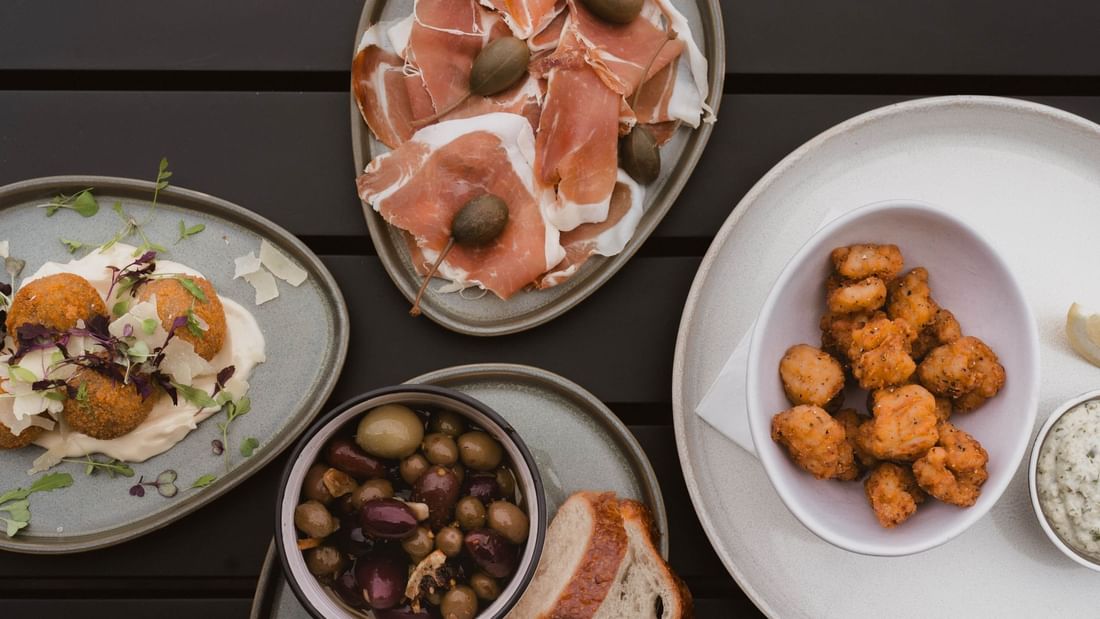 Delightful spread of charcuterie, olives, and fried bites served in The Cellar Kitchen Bar at Novotel Barossa Valley Resort