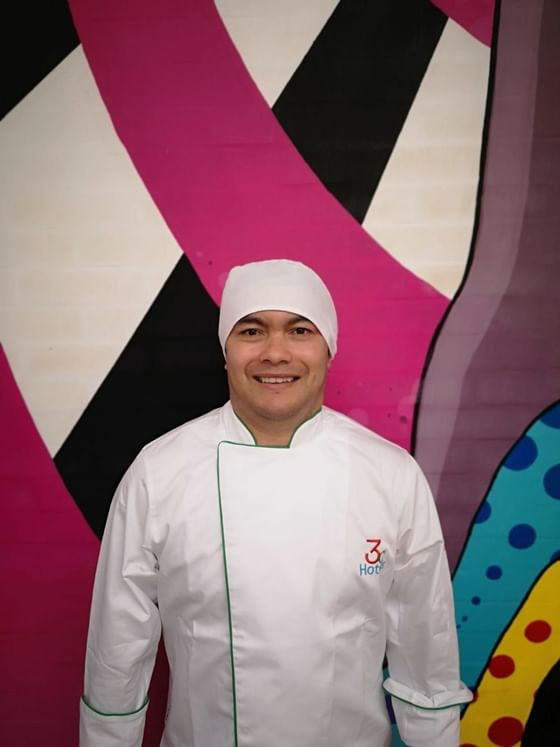 Chef posing by a pop art wall at 3C Hotels