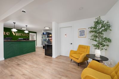 Lobby lounge with a reception desk and a snack area at The Varsity North, highlighting modern hotels in Centralia, WA