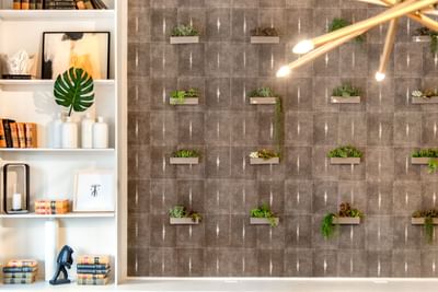 Green foliage hanging on the wall in the Business Center with warm lighting at The Riverwalk Plaza Hotel