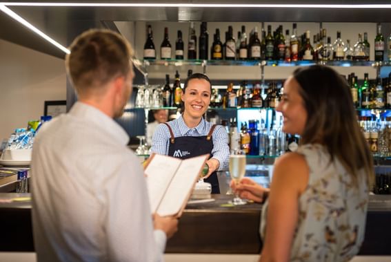 Couple by the counter in Altitude Bar at Cradle Mountain Hotel