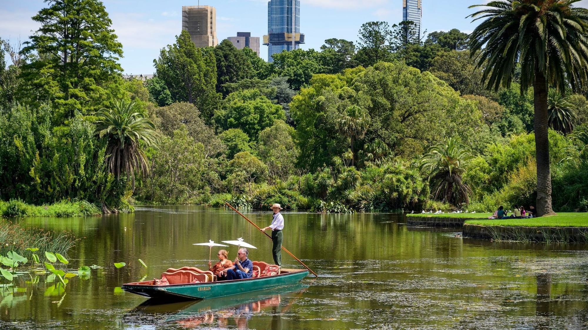 Couple experiencing a boat ride in Royal Botanic Gardens near Quay West Suites Melbourne