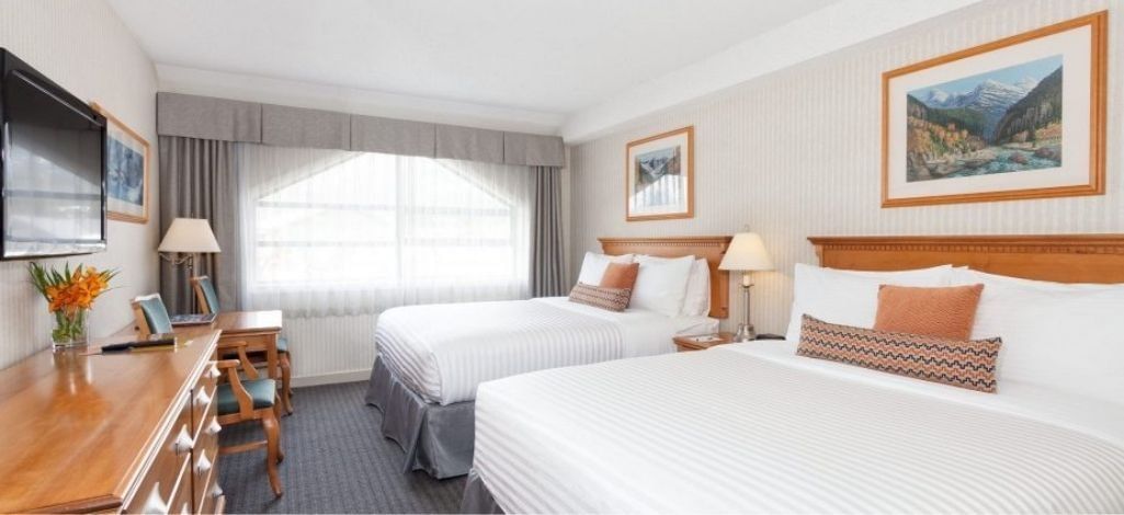 Guest room with two queen beds at Listel Whistler, a Coast Hotel.
