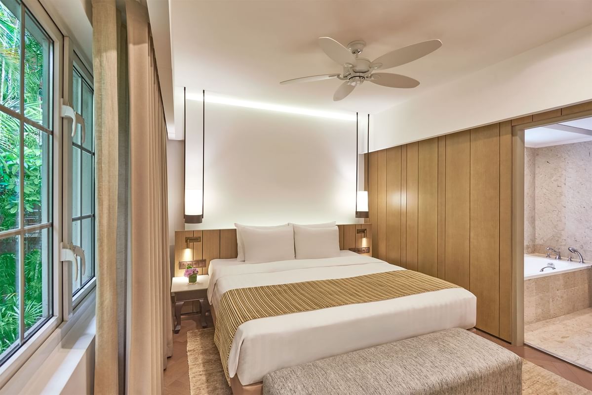 Interior of Junior Suites with comfy bed & separate bathroom area at Goodwood Park Hotel