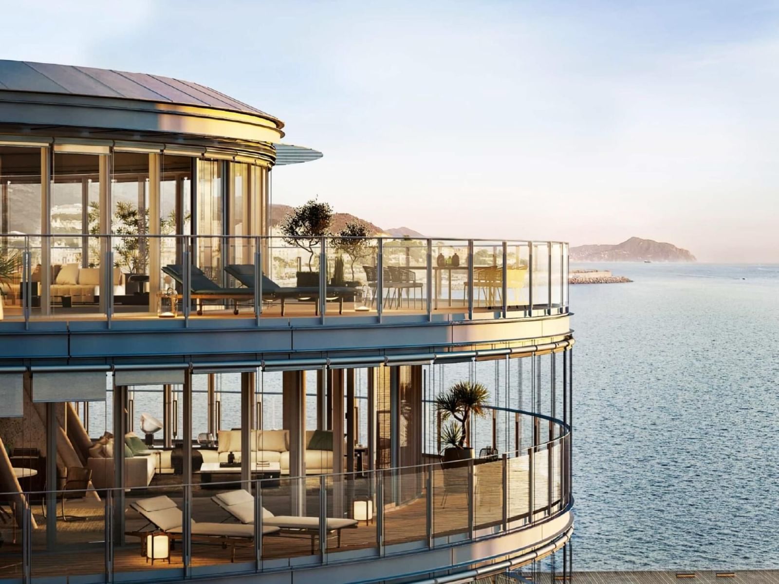 Modern circular balcony at Waterfront di Levante with lounge chairs and scenic sea views at sunset near AG Hotels
