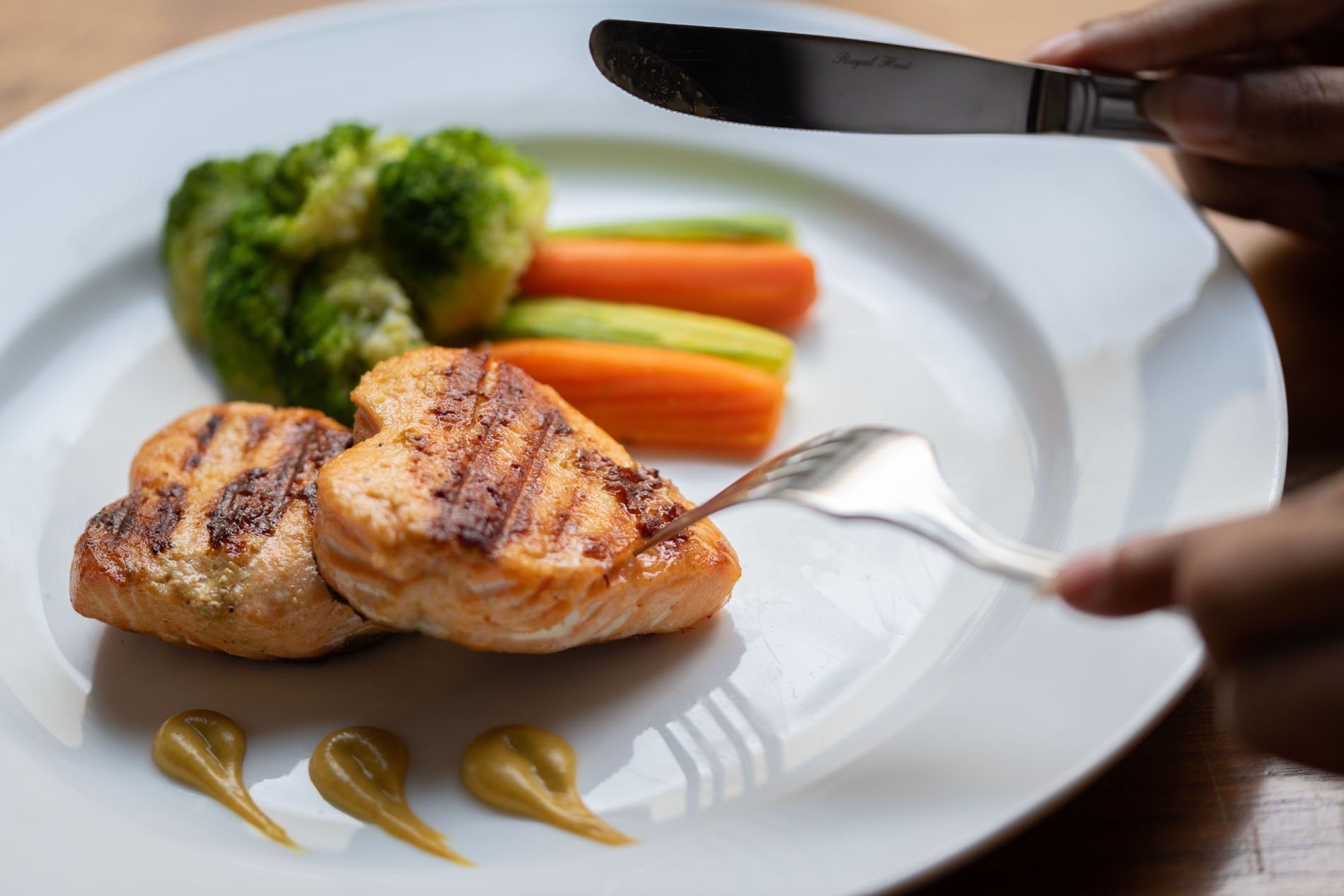 Grilled heart-shaped salmon fillets served alongside steamed broccoli & carrots in Seasons Restaurant at Warwick Hotel Jeddah