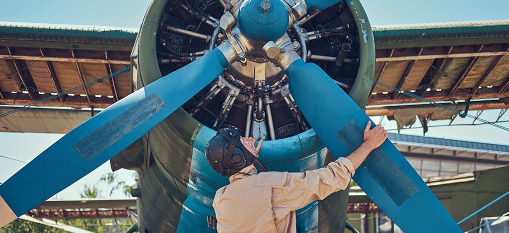 pilot mechanic holding an airplane propeller