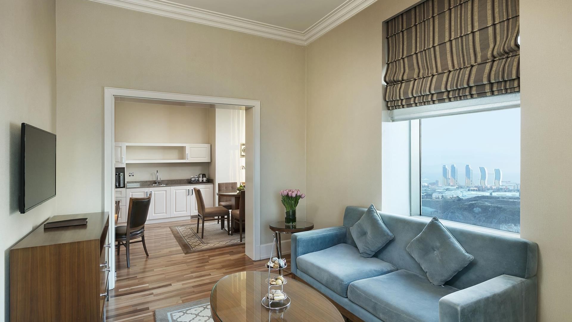 Living area arranged with cozy sofa and a TV in Premier Suite at Titanic Business Kartal
