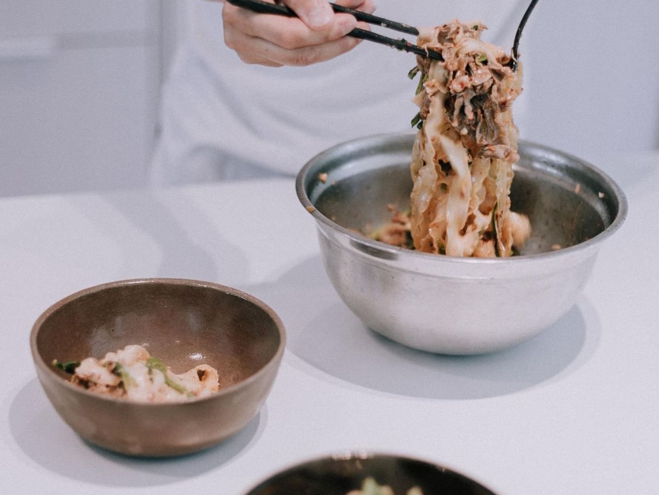 Private chef preparing a noodle dish at H2O Life Style Resort