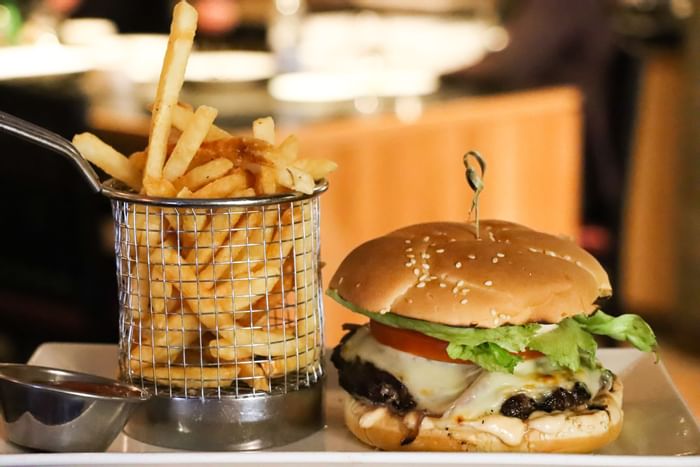 Close-up of a burger served with French fries at Hotel Halifax