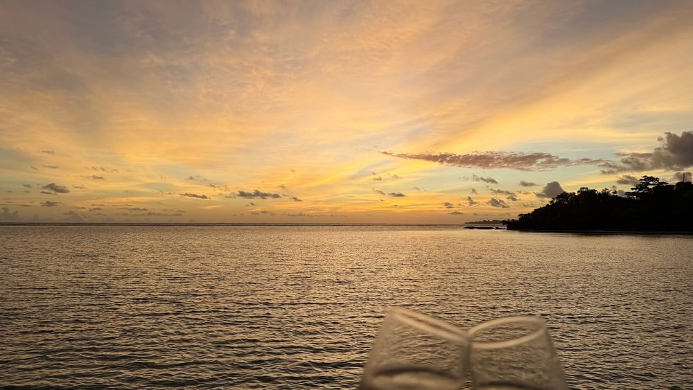 Two glasses of champagne at sunset over the ocean at Warwick Le Lagon - Vanuatu, Efate.