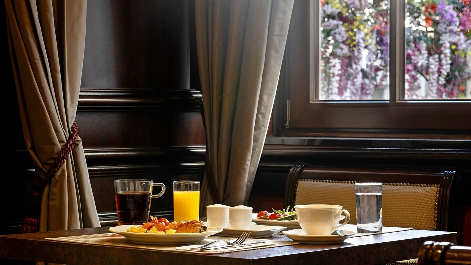 Fresh breakfast with coffee and orange juice with ark wood paneling at Hotel Barsey by Warwick