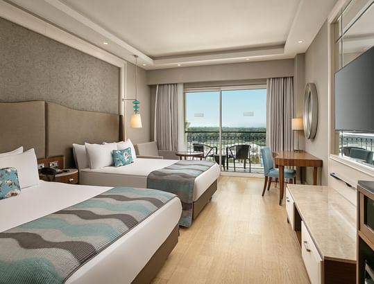 TV & work desk facing the beds in Standard Room with wooden floors at Titanic Deluxe Golf Belek