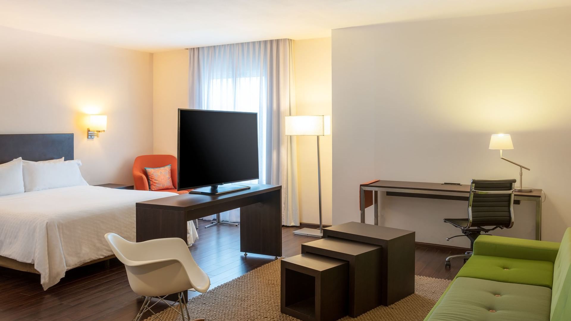 King bed & furniture in a junior suite at Fiesta Inn Hotels