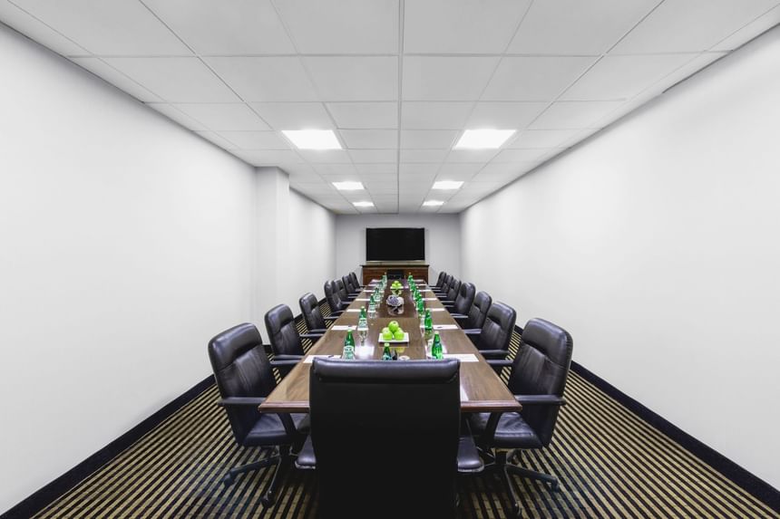 Meeting room with chairs and a long table at APA Hotel Woodbridge