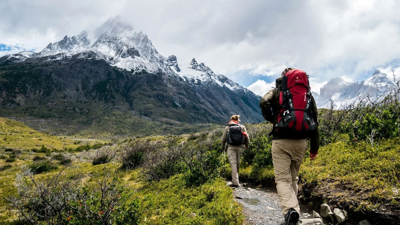 Two hikers exploring a mountain trail in Canmore.