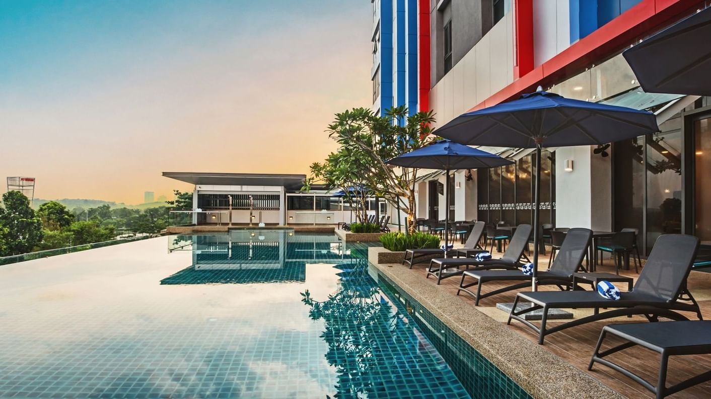 The hotel pool is bordered by comfortable lounge chairs at Sunway Hotel Big Box