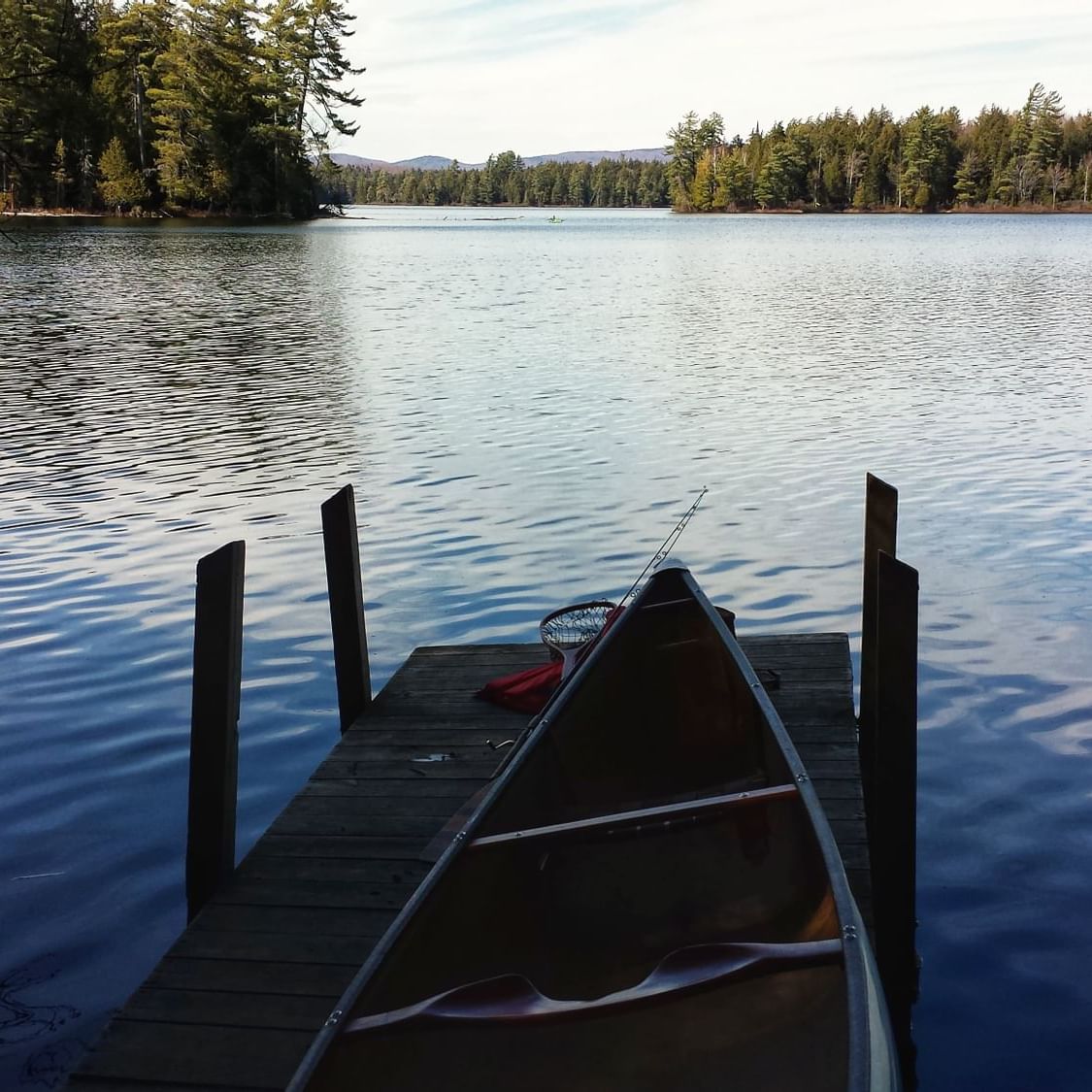 A canoe by a boat dock at Horseshoe Pond near High Peaks Resort